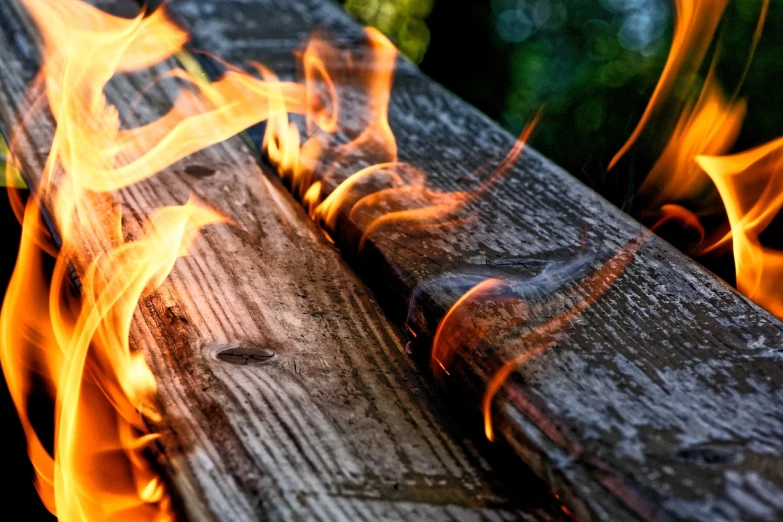 a close up of a piece of wood on fire, a picture, by Rodney Joseph Burn, pexels, auto-destructive art, rails, morning glow, fireflys, spoiler