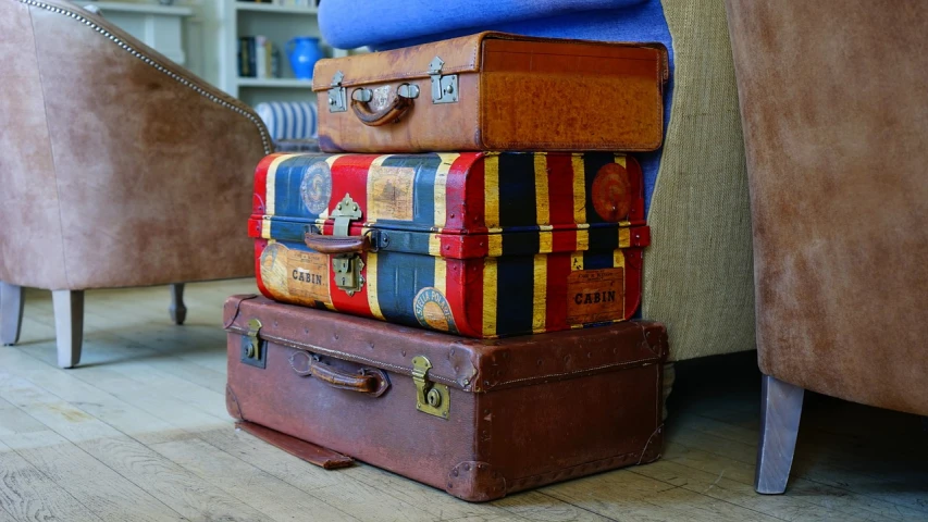 a stack of luggage sitting on top of a wooden floor, a portrait, by Walenty Wańkowicz, pixabay, maximalism, 1970s photo, 🦩🪐🐞👩🏻🦳, moving castle, trio