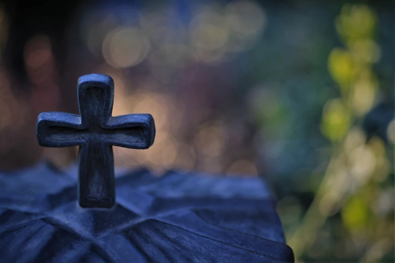 a wooden cross sitting on top of a grave, a picture, unsplash, bokeh, carved from sapphire stone, profile picture, gothic background