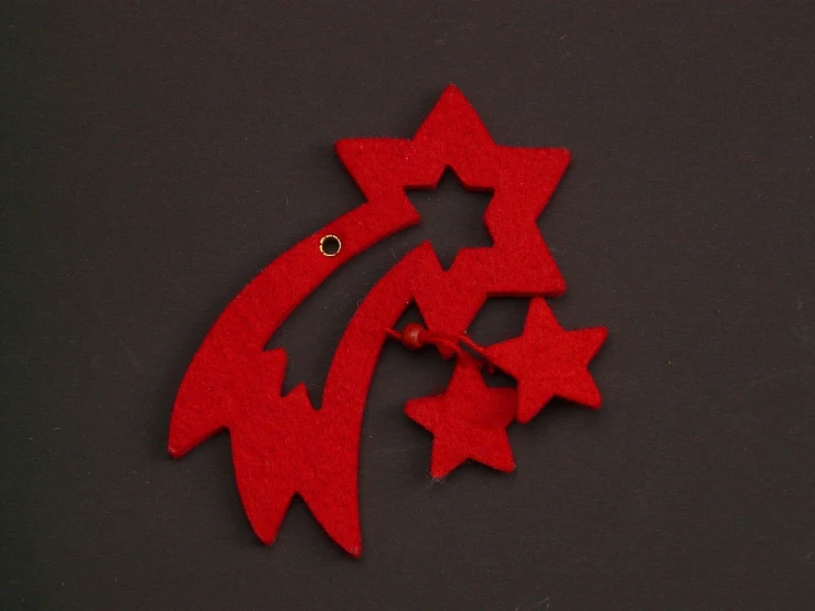 a red christmas ornament sitting on top of a table, inspired by Jean Arp, stars and nebula, felt, - h 1 0 2 4, lapel