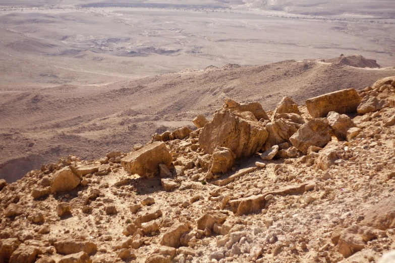 a person riding a horse on top of a rocky hill, a tilt shift photo, israel, mars landscape, high details photo