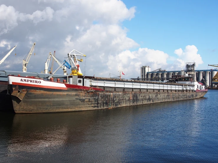 a large boat sitting on top of a body of water, a portrait, inspired by Tilo Baumgärtel, flickr, shipping docks, watch photo, silo, enormous scale