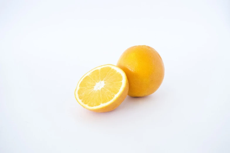two oranges cut in half on a white surface, a picture, half body photo