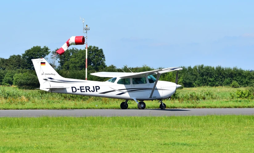 a small airplane sitting on top of an airport runway, a picture, inspired by Jürg Kreienbühl, flickr, plein air, pulling the move'derp banshee ', hip skirt wings, basic photo, banner