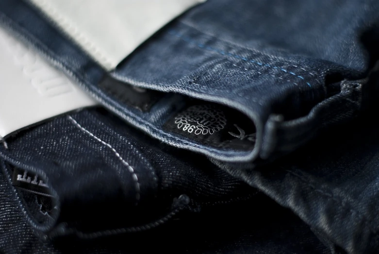 a close up of the pocket of a pair of jeans, a picture, by Adam Chmielowski, depth of field”, detailed product shot, high detail”