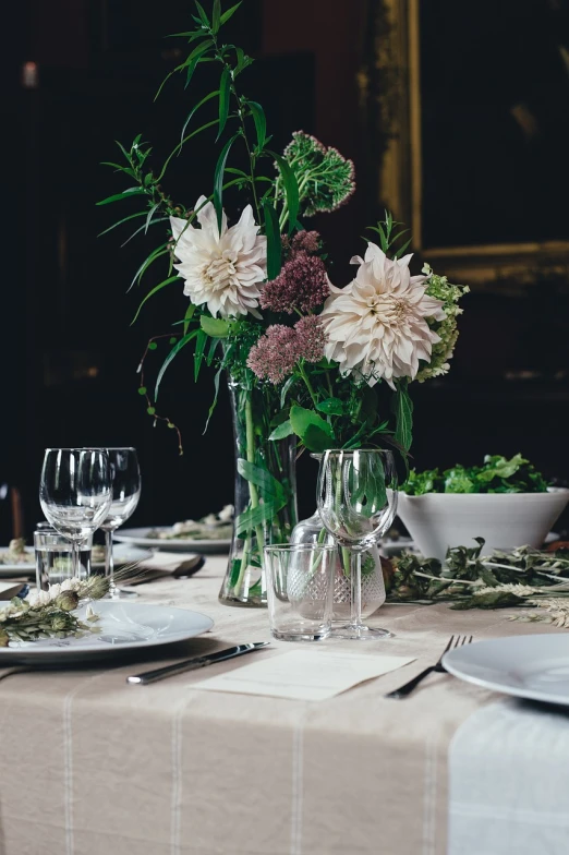 a vase filled with flowers sitting on top of a table, pexels, scene from a dinner party, light greens and whites, elegantly dressed, 🤬 🤮 💕 🎀