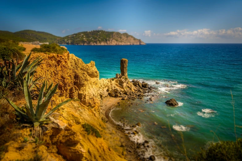 a view of the ocean from a cliff, a tilt shift photo, by Maurice Esteve, shutterstock, renaissance, old ruins tower, ibiza, pillar, ¯_(ツ)_/¯