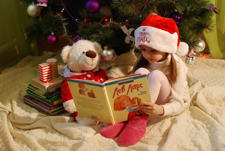 a little girl reading a book in front of a christmas tree, a picture, teddy bear, cute girls, leonid, reading engineering book