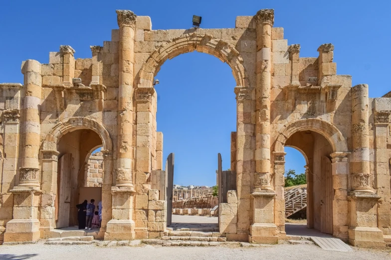 a couple of people that are standing in front of a building, by Edmond Aman-Jean, shutterstock, neoclassicism, huge giant old ruins, steel archways, jordan, mini amphitheatre