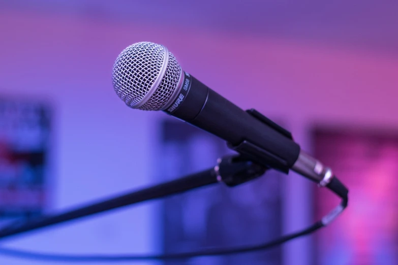 a close up of a microphone on a stand, shutterstock, happening, blue and purle lighting, background image, event photography, garner holt