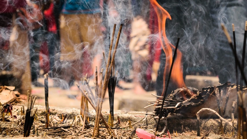 a bunch of sticks sticking out of the ground, a picture, by Richard Carline, shutterstock, incense smoke fills the air, unholy ceremony, cambodia, stock photo