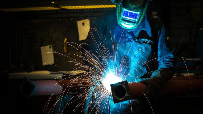 a welder working on a piece of metal, by Matt Cavotta, pixabay, stock photo, afp, version 3, framing