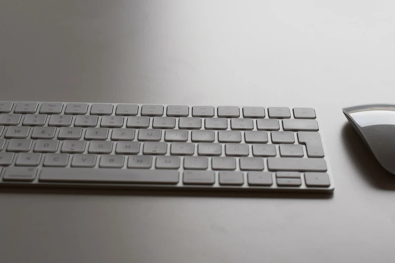 a computer keyboard and mouse on a table, by Andrei Kolkoutine, minimalism, grayish, crisp image texture, apple, lacquered