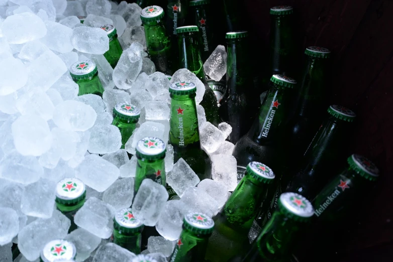 a bunch of bottles of beer sitting on top of ice, a picture, by Hermann Rüdisühli, afp, version 3, deep green, red bull