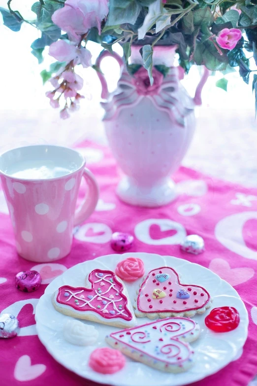 a plate of cookies and a cup of coffee on a table, inspired by Peter Alexander Hay, pixabay, romanticism, vibrant pink, hearts, 🌸 🌼 💮, milkshake