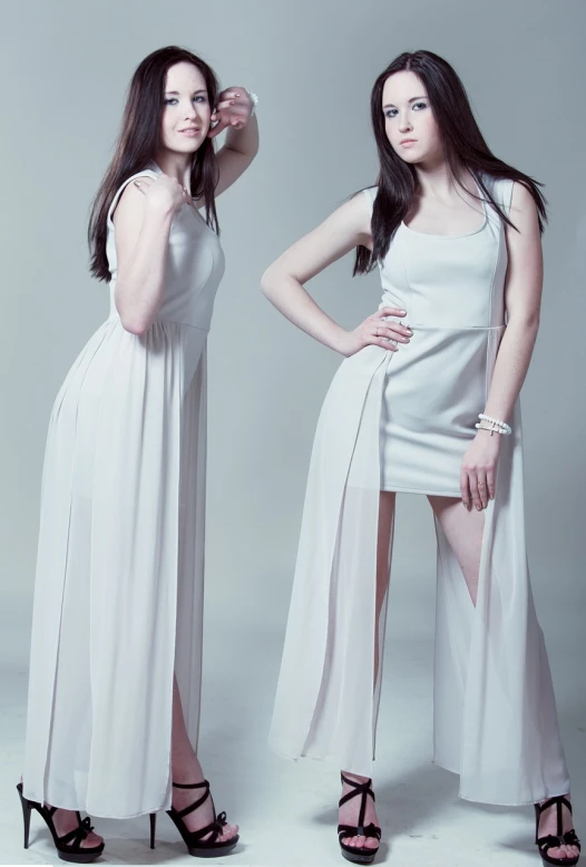 a couple of women standing next to each other, inspired by Wang Duo, full body white dress, studio portrait photography, pale skin!, fashion color studio lighting