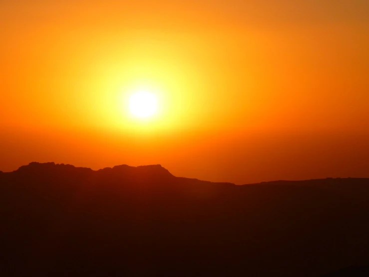 the sun is setting over a mountain range, a picture, romanticism, egypt, orange yellow ethereal, hot summer sun, sunbathed skin