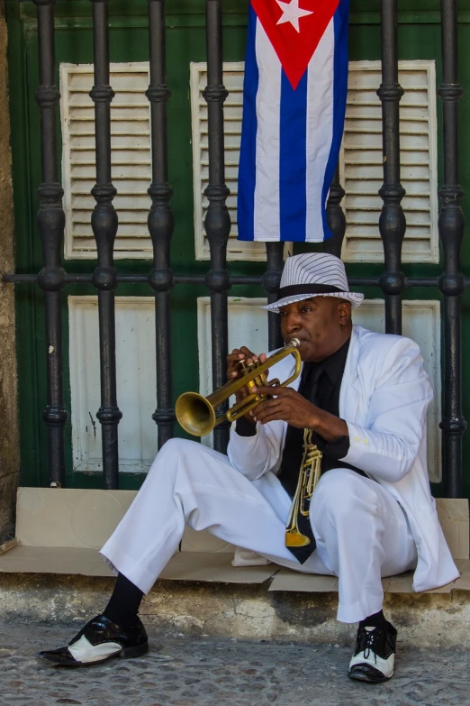 a man in a white suit playing a trumpet, by Scott M. Fischer, pexels, funk art, cuban setting, a quaint, resting, usa-sep 20