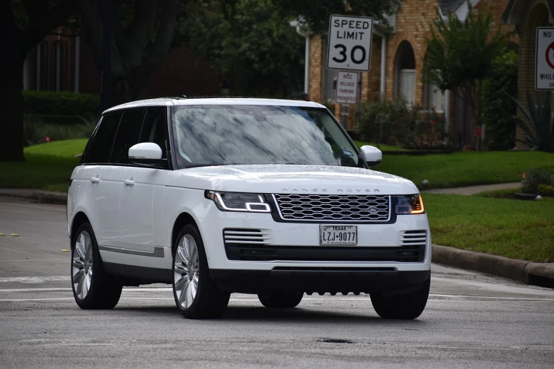 a white range rover driving down a street, a picture, by Robbie Trevino, usa-sep 20, b - roll, test, h 640