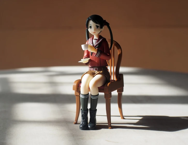 a doll sitting in a chair with a cup of coffee, a statue, by Hiroyuki Tajima, school girl, nice afternoon lighting, with black pigtails, 4 5 mm. photorealistic