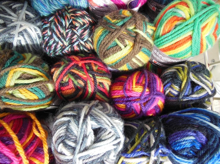 a pile of yarn sitting on top of a table, flickr, kaleidoscopic, colorful”, grain”