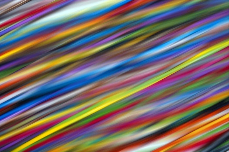 a blurry photo of a multicolored background, inspired by Morris Louis Bernstein, flickr, abstract illusionism, diagonal composition, colorful wires, long exposure photo