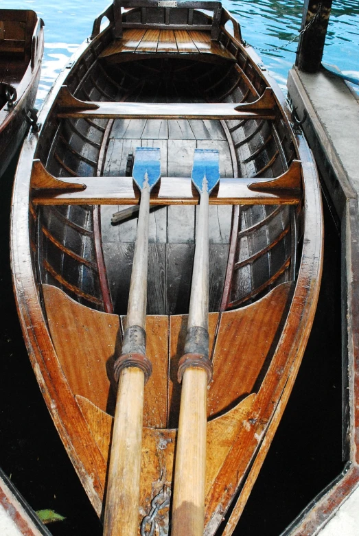 a row boat sitting on top of a body of water, a portrait, by Edward Corbett, flickr, mechanical detail, twins, ship interior, dipstick tail