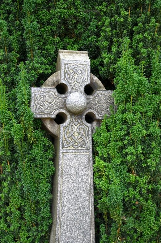 a stone cross sitting on top of a lush green forest, inspired by Brigid Derham, pixabay, symbolism, celtic braid, london cemetery, detiled, high - intricate - detail