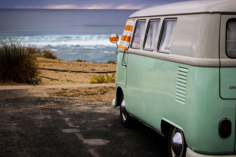 a vw bus parked on the side of a road next to the ocean, by Matthias Weischer, unsplash, sea - green and white clothes, orange and teal, wallpaper - 1 0 2 4, bottom angle