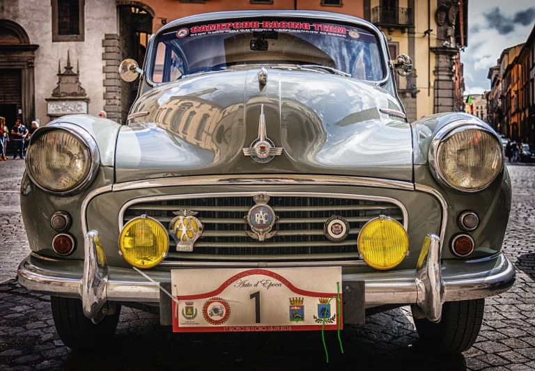 a classic car parked on a cobblestone street, a portrait, by Francesco Furini, pixabay contest winner, photorealism, round cheeks, scarab, silver crown, kodachrome 6 4