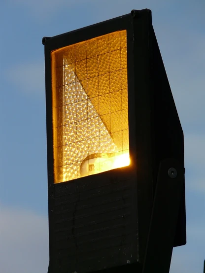 a close up of a traffic light with a sky background, a picture, by Dave Allsop, realism, solar sail infront of sun, photo taken at night, gold dappled light, dunce