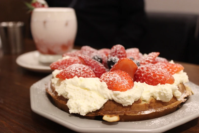 a close up of a plate of food on a table, stroopwaffel, 🎀 🗡 🍓 🧚, whipped cream on top, japanese akihabara cafe