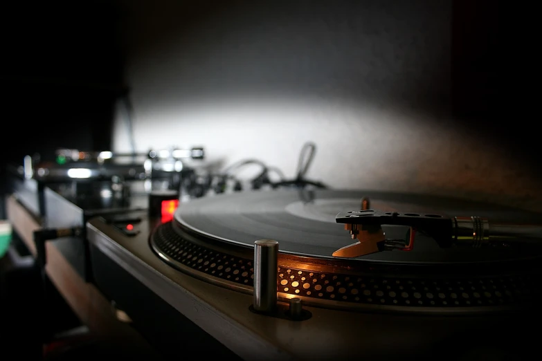 a turntable sitting on top of a wooden table, flickr, [ realistic photography ], dramatic lighting”