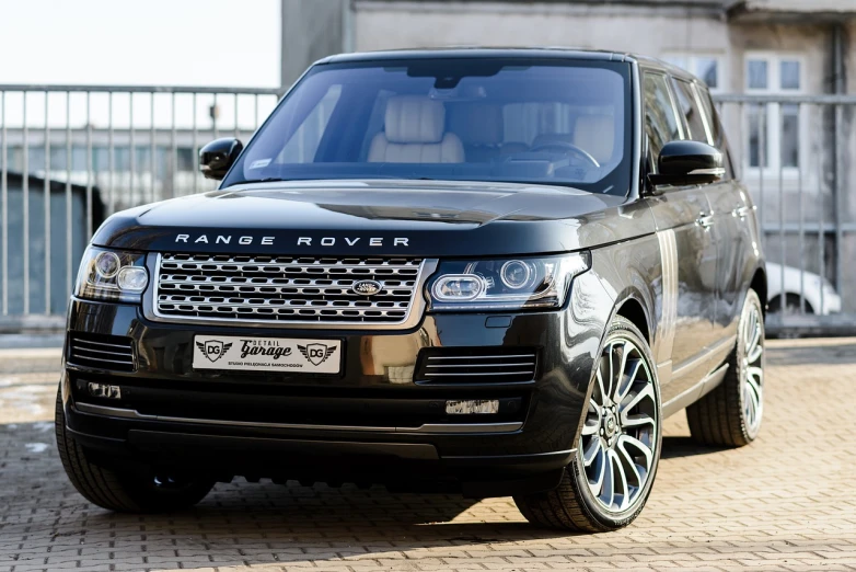 a black range rover parked in front of a building, a picture, shutterstock, ultra realistic hd, style of vogelsang, highly polished, voge photo