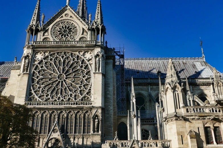 a large cathedral with a clock on the front of it, gothic art, elaborate latticed balconies, taken in 2022, paris city, cathedral of sun