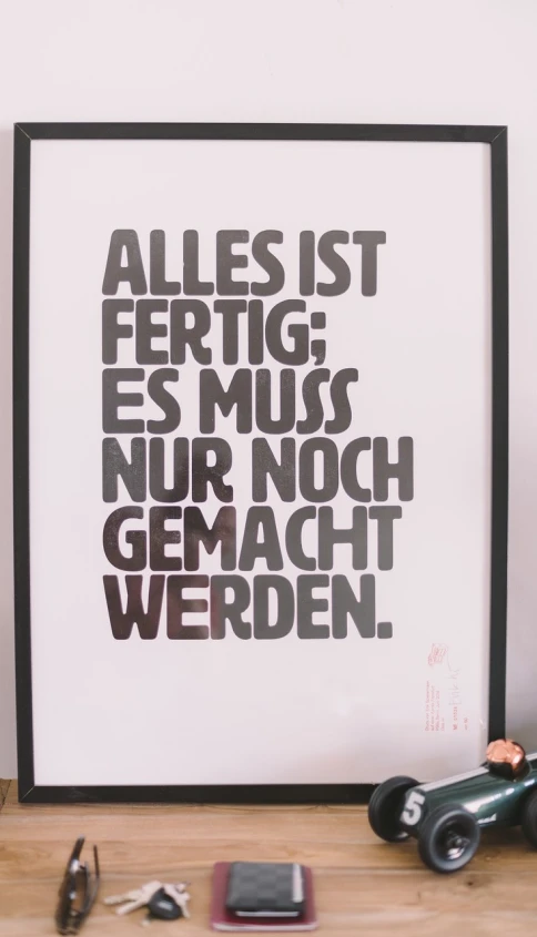 a poster sitting on top of a wooden table, by Georg Schrimpf, tumblr, arbeitsrat für kunst, all inside frame, motivational poster, lettering, twas brillig