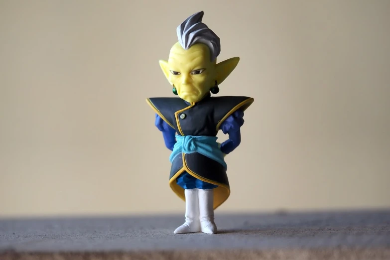 a close up of a toy figure on a table, inspired by Yerkaland, dragon ball super, portrait mode photo, vertically flat head, goblin