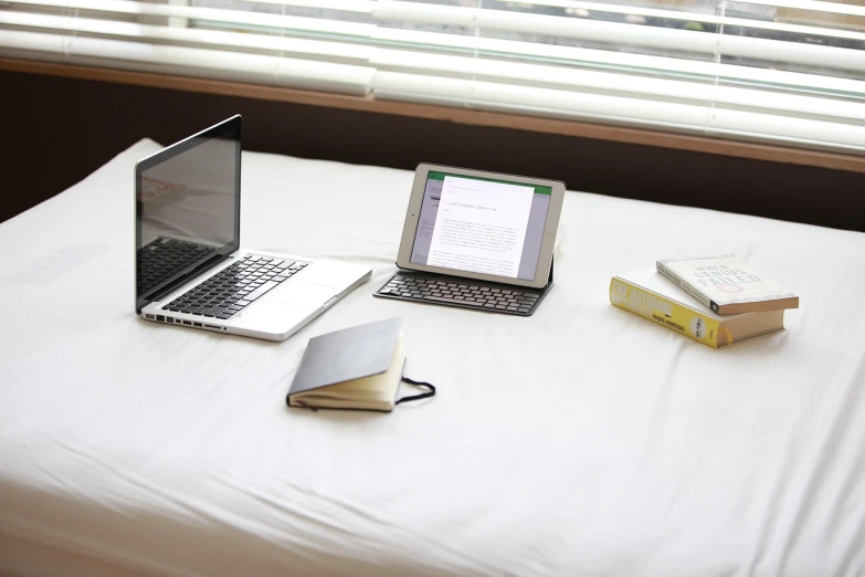 a couple of laptops sitting on top of a bed, by Gawen Hamilton, notebook, high res photo, small room in tokyo, student