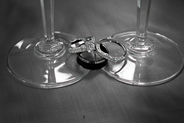 a couple of wine glasses sitting next to each other, by Joy Garnett, flickr, ring flash closeup photograph, black and silver, infinity, trio
