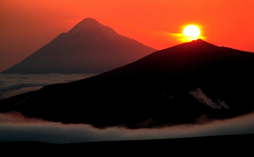 the sun is setting on the top of a mountain, by Andrei Kolkoutine, volcano fog, dmitry bogdanov, red sun in the background, ancient”