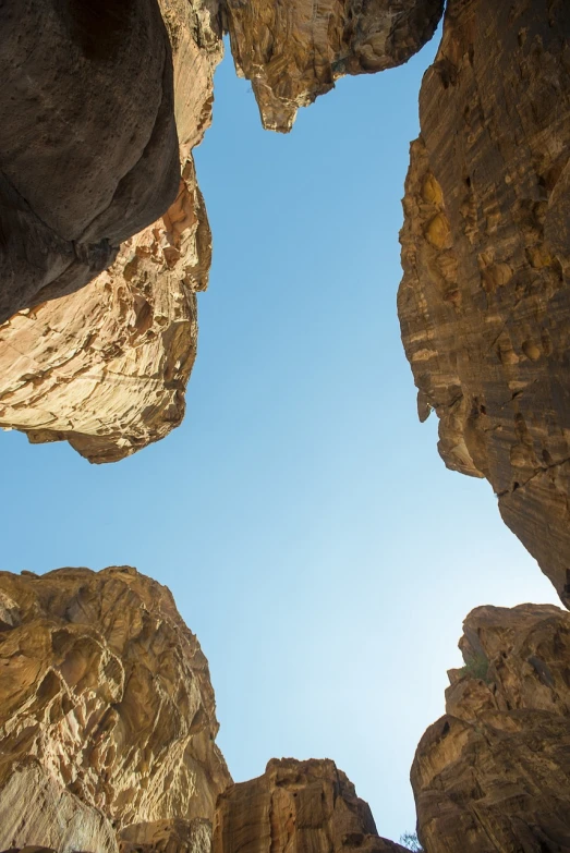 there is no image here to provide a caption for, by Matthias Weischer, shutterstock, brown canyon background, perspective from below, sunny day time, high rocks