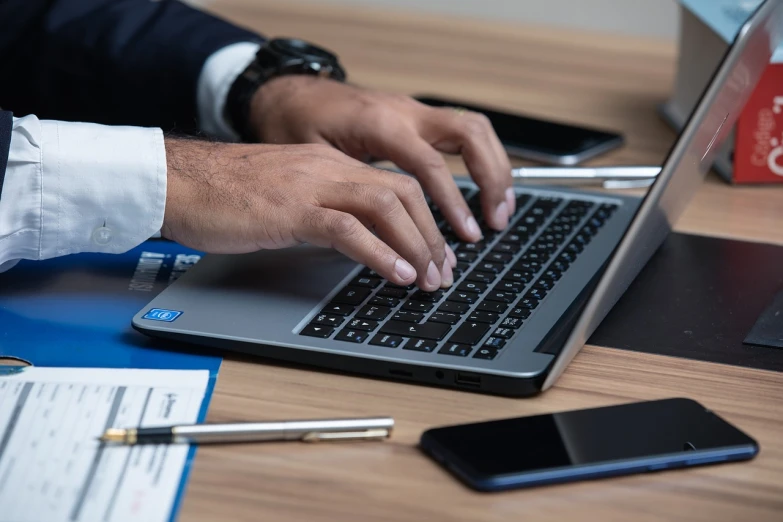 a close up of a person typing on a laptop, a stock photo, by Jakob Gauermann, shutterstock, arbeitsrat für kunst, lawyer, high angle close up shot, gentleman, stock photo