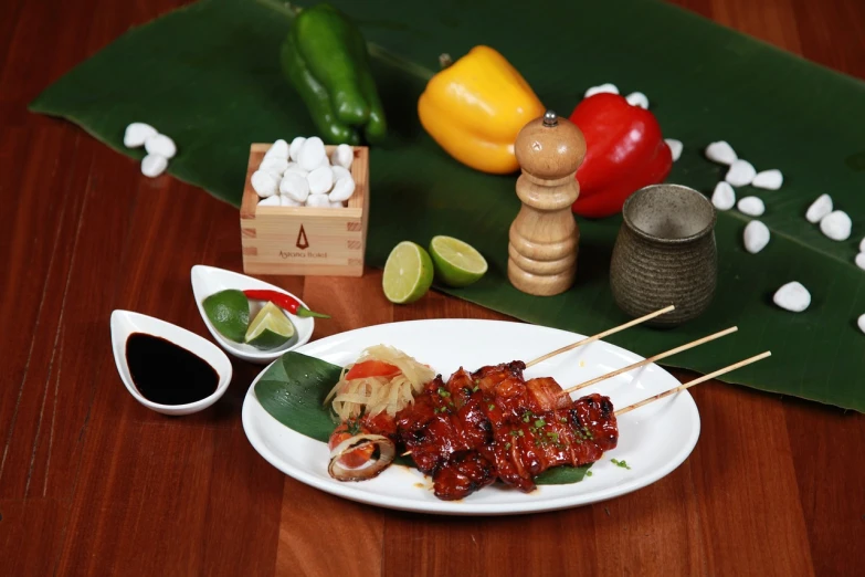 a close up of a plate of food on a table, inspired by Kanō Tan'yū, skewer, product photo, malaysian, a wooden