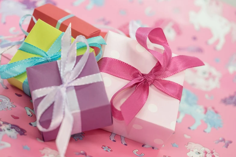 a couple of gift boxes sitting on top of a table, pixabay, pink and triadic color scheme, bows, wallpaper mobile, clamp