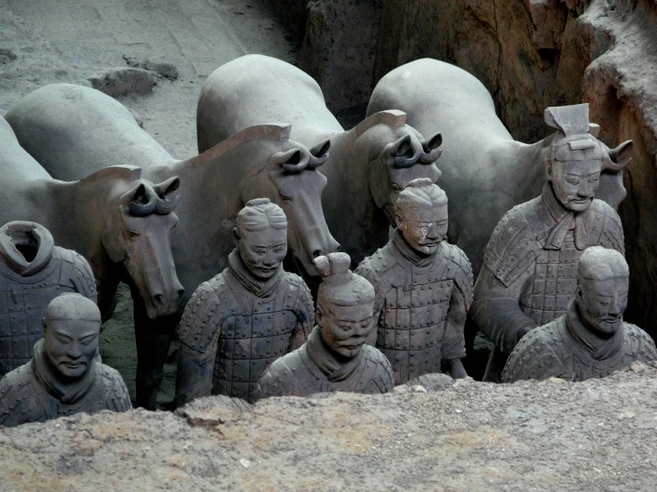 a group of statues sitting next to each other, a statue, inspired by Ma Shi, pexels contest winner, mule, afp, chinese armor, mud