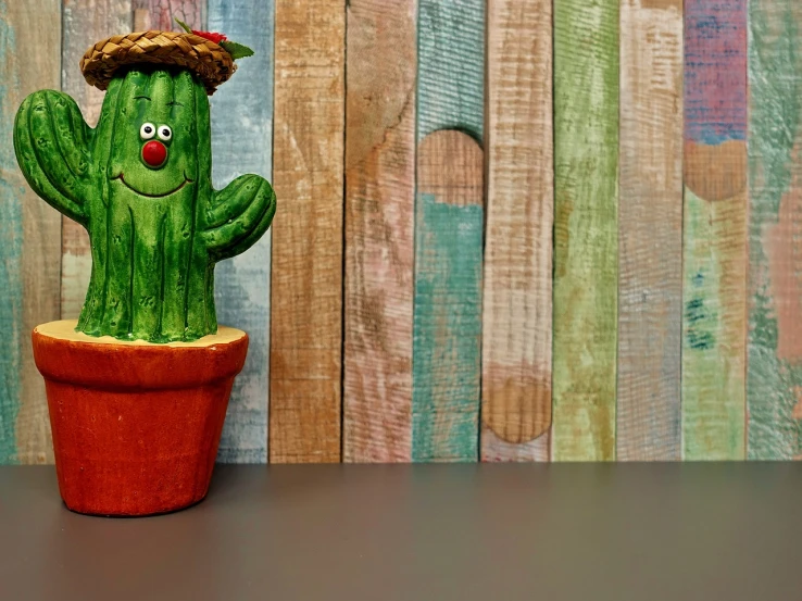 a close up of a cactus with a hat on, a picture, folk art, office cubicle background, made of wood, product introduction photo, shelf