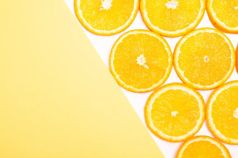 a group of sliced oranges sitting on top of a table, a stock photo, postminimalism, background image, on a yellow paper, on white background, product introduction photo