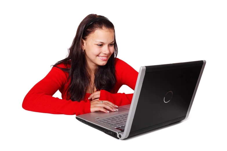 a woman sitting in front of a laptop computer, a photo, long hair and red shirt, woamn is curved, dlsr photo, stockphoto