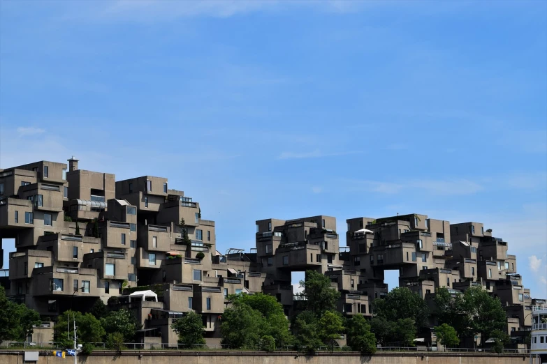 a tall building sitting on top of a lush green hillside, by Gawen Hamilton, flickr, brutalism, habitat 67, mandkaws, staggered terraces, rhode island