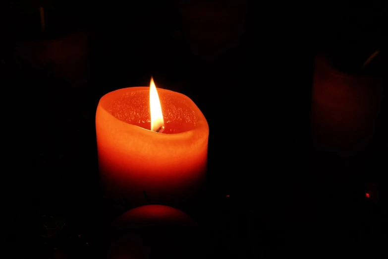 a lit candle sitting on top of a table, a picture, pexels, hurufiyya, dark orange black white red, profile picture 1024px, istockphoto, floating embers